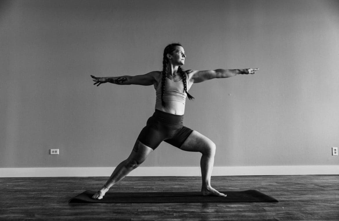 Yoga practitioner in warrior pose from the Soul Deep Yoga class styles section.