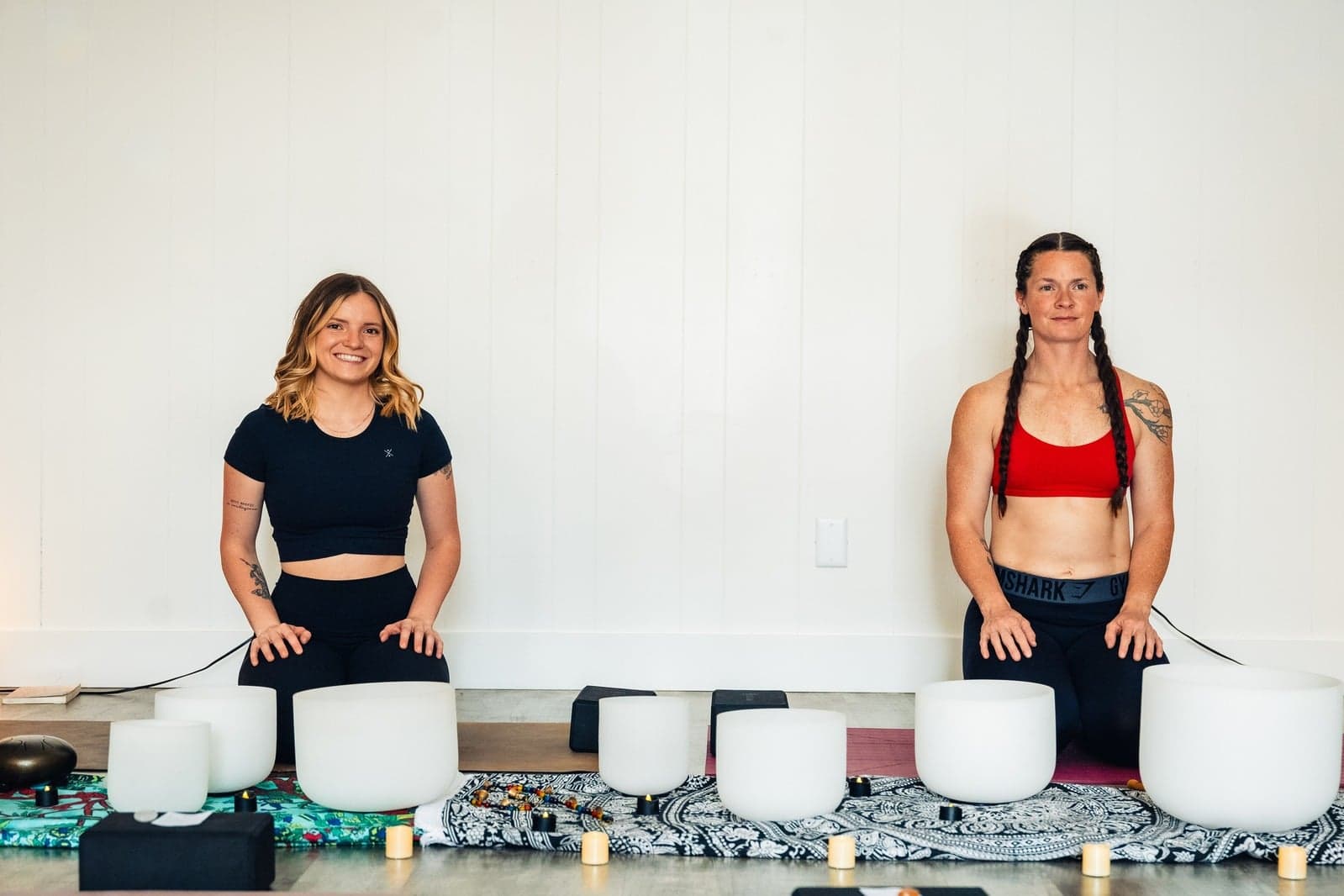 Soul Deep Yoga team members seated with crystal singing bowls.